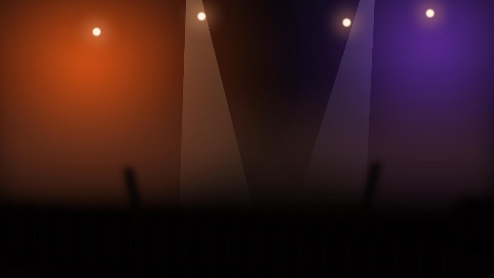 The stage at OUTHERE in low orange and violet light, haze over the crowd.